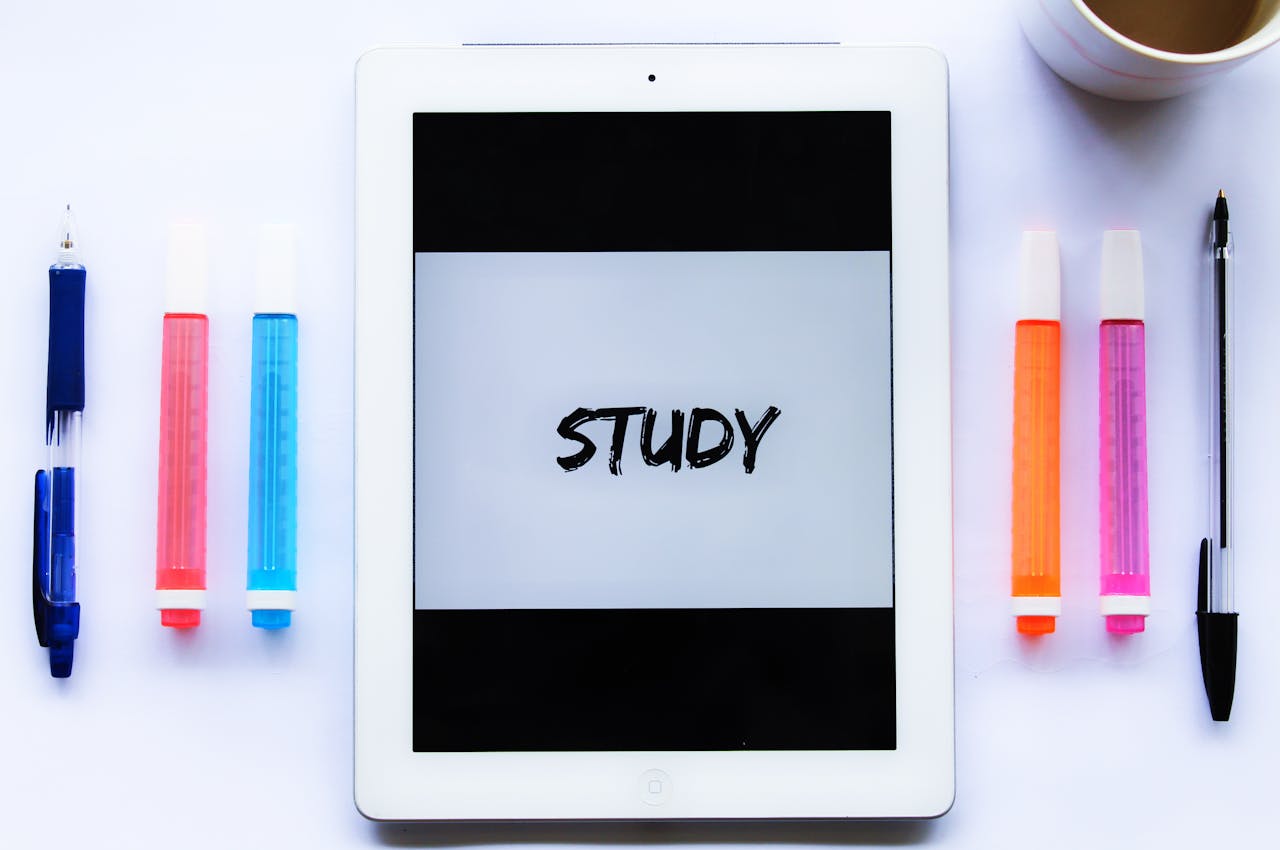 Study setup with tablet and colored pens enhancing a learning environment.